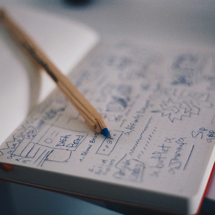 Ideas and sketches written in a notebook.