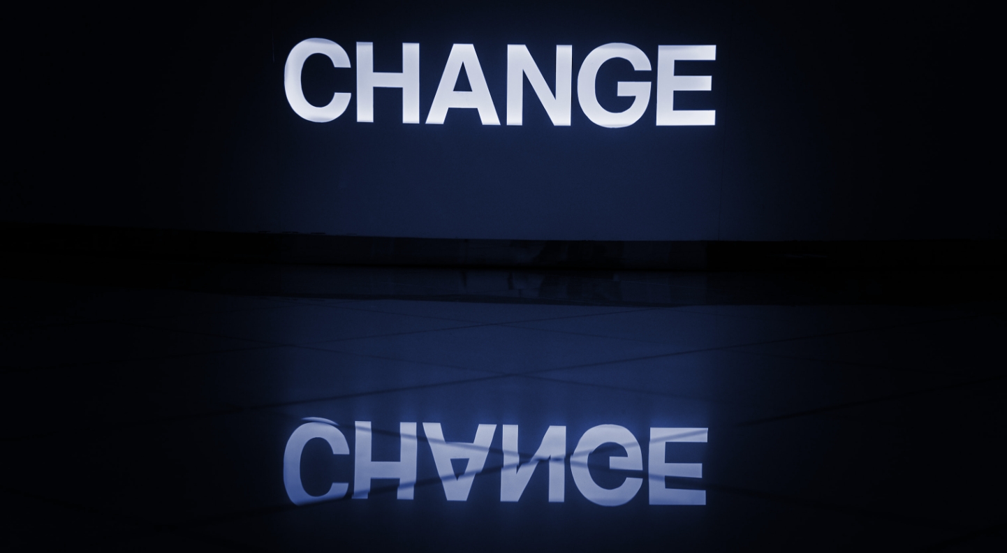 The text spelling the word change and it's reflection on floor tiles.